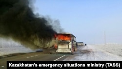 KAZAKHSTAN -- A view shows a burning bus on a route used by migrant workers heading to Russia, in the Aqtobe region, January 18, 2018 