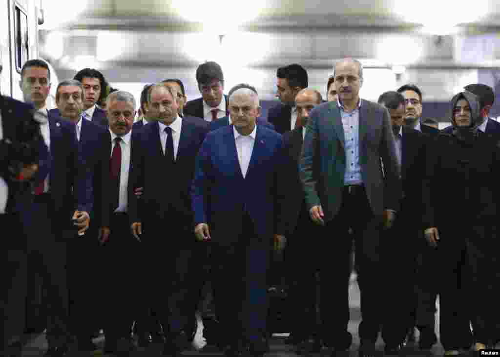 Turkey's Prime Minister Binali Yildirim (center) leaves after a press conference at the airport following the attacks. (Reuters/Murad Sezer)